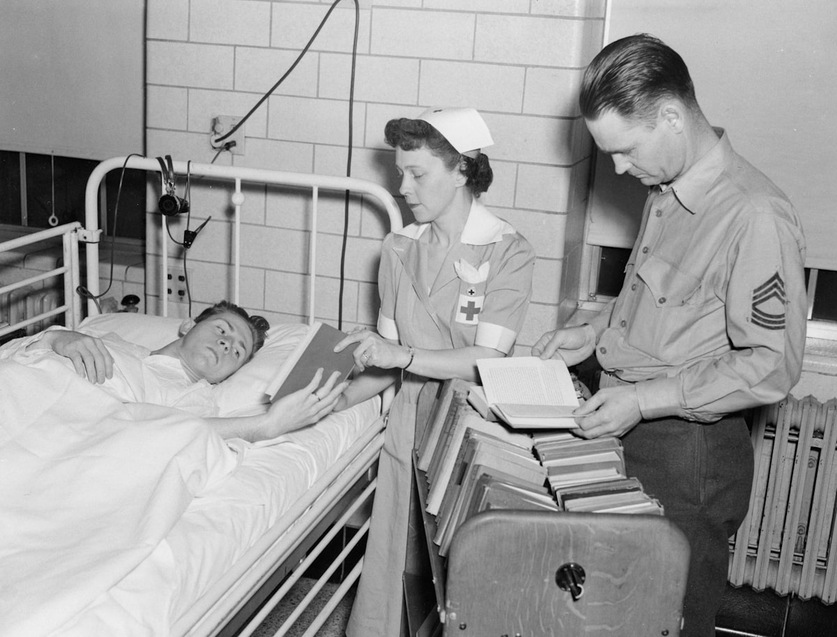 14-1011-042 print 8x10 b&w Mobile library. Red Cross Nurse assists patients with books. [Recreation][Nurses][Patients]Quantico, VA Navy Medicine Historical Files Collection - Facilities related to Ultimate Guide to Choosing the Perfect Bed in a Bag Set