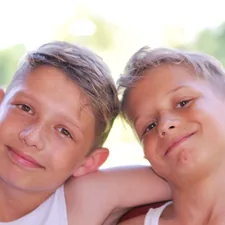 2 boys smiling during daytime related to Building a Simple Twin Bed Frame: A Step-by-Step Guide