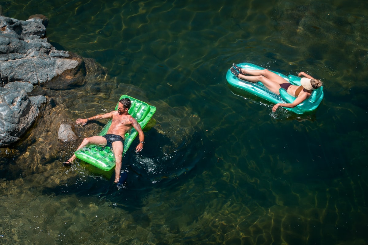 2 women in green and black bikini lying on green inflatable float on water during daytime related to Discovering the Best Deals on Inflatable Beds at Costco