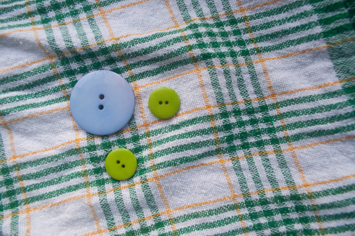 3 buttons on a piece of plaid cotton fabric. related to Blue Plaid Valance