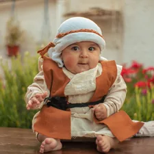 a baby sitting on a table related to Galactic Dreams: A Guide to Baby Bedding Inspired by a Galaxy Far, Far Away