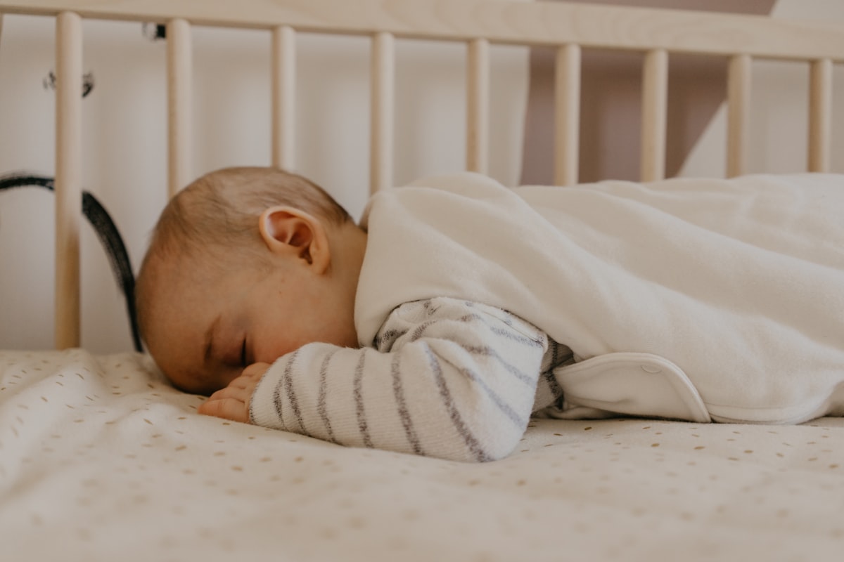 a baby sleeping in a crib related to The Ultimate Guide to Finding the Perfect Baby Bed on Amazon