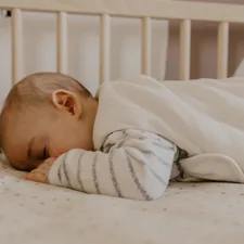 a baby sleeping in a crib related to The Ultimate Guide to Finding the Perfect Baby Bed on Amazon