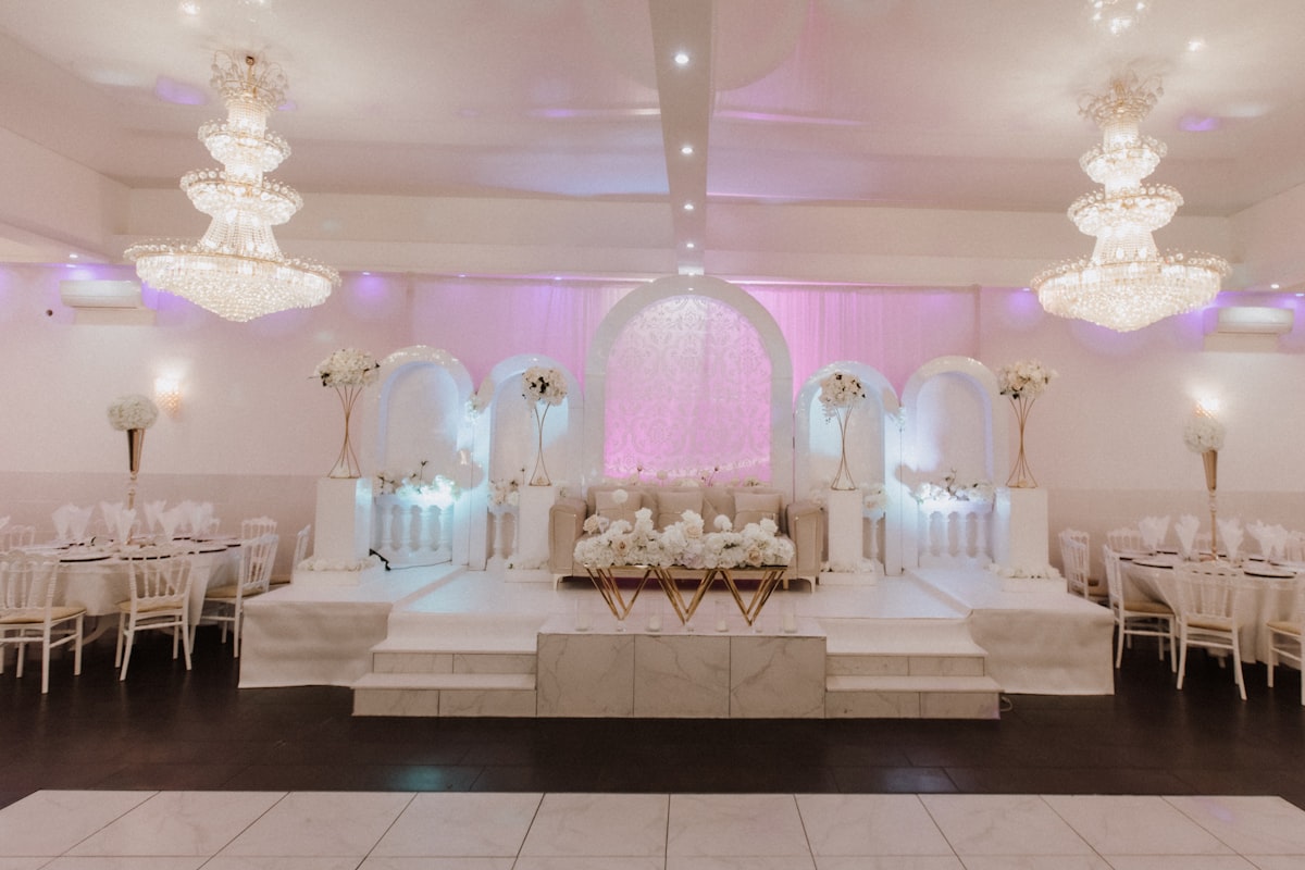 a banquet hall with tables and chairs and chandeliers related to Affordable Elegance: The Ultimate Guide to Cheap Platform Bed Frames