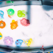 a bath tub filled with lots of different colored toys related to Make a Splash with Bubble Guppies Bedding