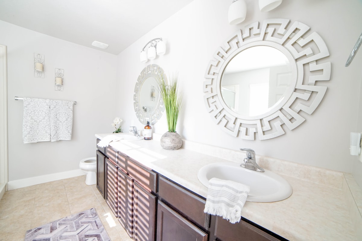 a bathroom with a large mirror and a sink related to Elevate Your Bathroom Decor with a Shower Curtain and Window Valance Set