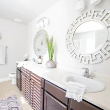 a bathroom with a large mirror and a sink related to Elevate Your Bathroom Decor with a Shower Curtain and Window Valance Set