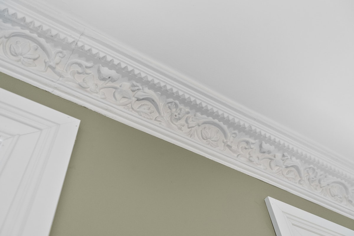 A bathroom with a mirror and a light fixture related to How to Make a Cornice Valance