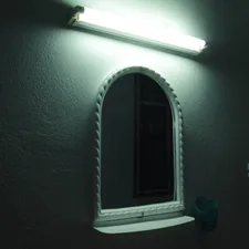 a bathroom with a mirror and a light on the wall related to Light Valance Molding: A Comprehensive Guide