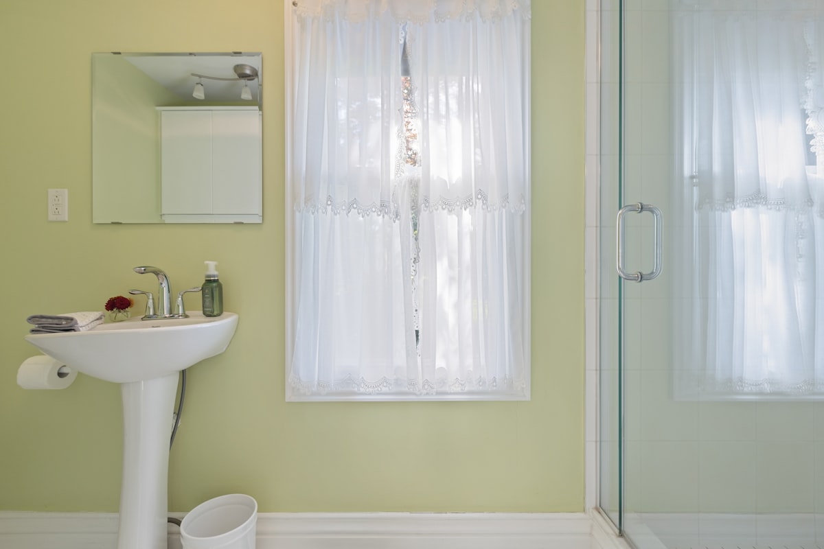 a bathroom with a sink and a shower related to Split Shower Curtains with Valance: Elevate Your Bathroom Style