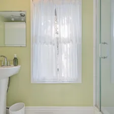 a bathroom with a sink and a shower related to Split Shower Curtains with Valance: Elevate Your Bathroom Style