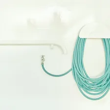 A bathroom with a toilet and a shower head related to The Ultimate Guide to Bidet Toilet Attachments: Revolutionizing Your Bathroom Experience