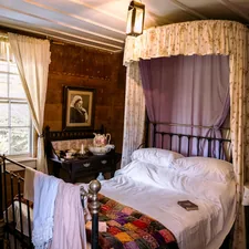 a bed in a room with a canopy over it related to Metal Canopy Bed: Revolutionizing Sleep