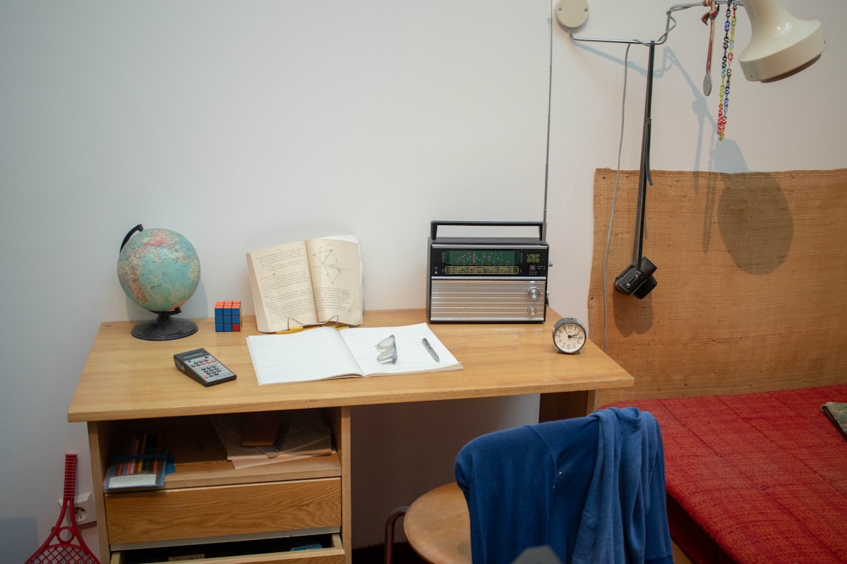 a bed room with a bed a desk and a radio related to Maximizing Space: Innovative Ideas for Combining Bed and Desk