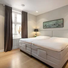 A bed room with a neatly made bed and a night stand related to Find Your Perfect Sleep, Redefined: Twin XL Bed In A Bag