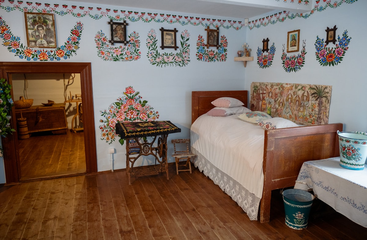 a bed room with a neatly made bed and a table related to Discover the Charm of Eureka Springs Bed and Breakfast