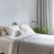 A bed sitting in a bedroom next to a window related to Toile Bedspreads and Coverlets: Comprehensive Guide