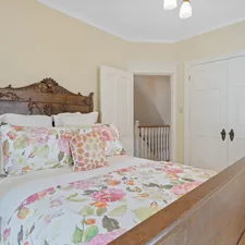 a bed with a floral comforter and pillows related to Bed and Breakfast in Alexandria, VA: Unforgettable Accommodations