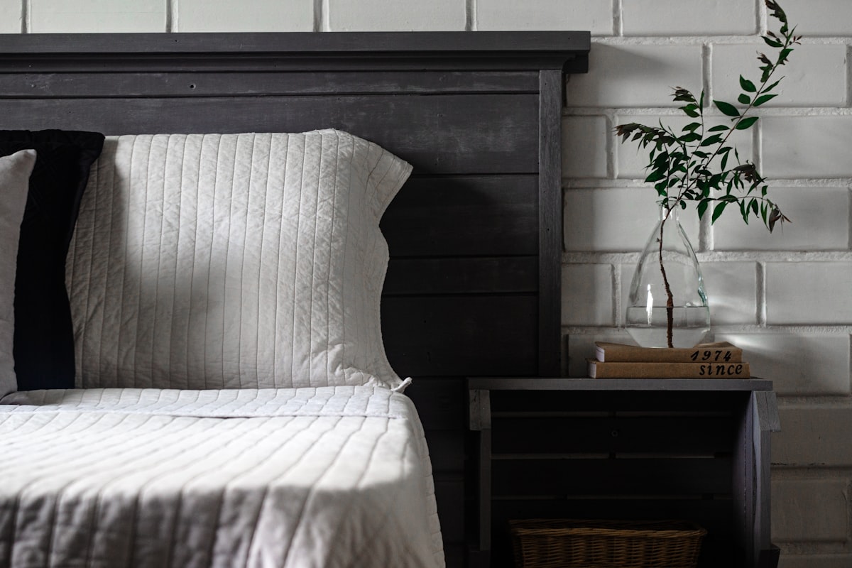 a bed with a vase of flowers related to The Timeless Elegance of King Quilts and Coverlets