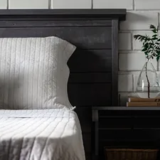 a bed with a vase of flowers related to The Timeless Elegance of King Quilts and Coverlets