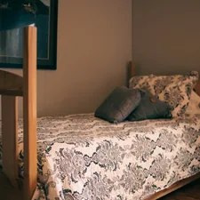 a bed with a wooden headboard and a picture on the wall related to Embrace Cozy Comfort: Exploring the Ultimate Twin Size Bed Experience