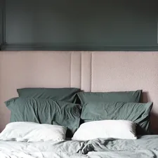 A bed with pillows and a lamp on a nightstand. related to The Luxurious Touch of Cotton Matelasse Coverlets: Elevating Your Home Decor