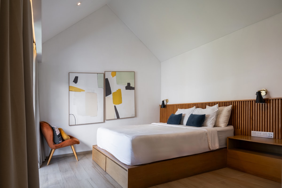 A bedroom with a bed and a chair in it related to Elevate Your Hotel's Style with High-Quality Coverlets