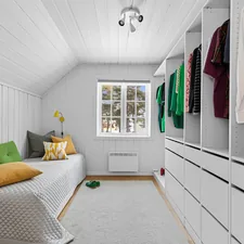 A bedroom with a bed and a closet related to Maximize Space with a Low Loft Bed: The Ultimate Guide