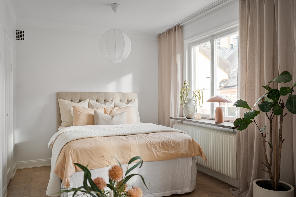 A bedroom with a bed and a plant in the corner related to Leirvik Bed Frame Review: A Stylish and Affordable Choice for Your Bedroom