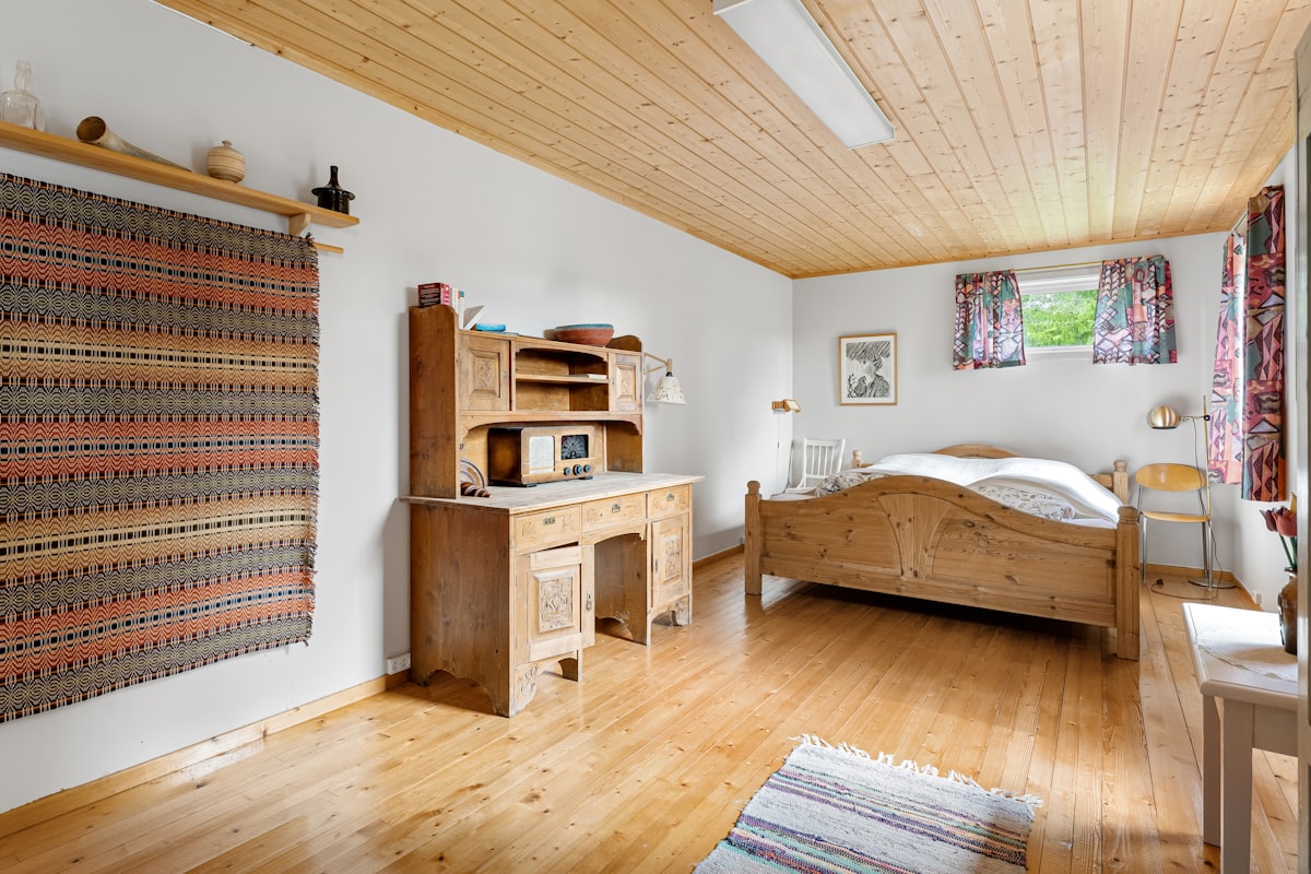 A bedroom with a bed, desk, and dresser related to Experience the Charm of Bed and Breakfast in Julian: A Cozy Getaway