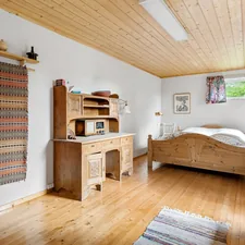 A bedroom with a bed, desk, and dresser related to Experience the Charm of Bed and Breakfast in Julian: A Cozy Getaway