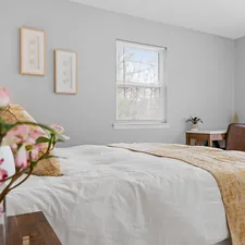 a bedroom with a bed, desk, and window related to Elevate Your Bedroom with a Queen Quilted Coverlet