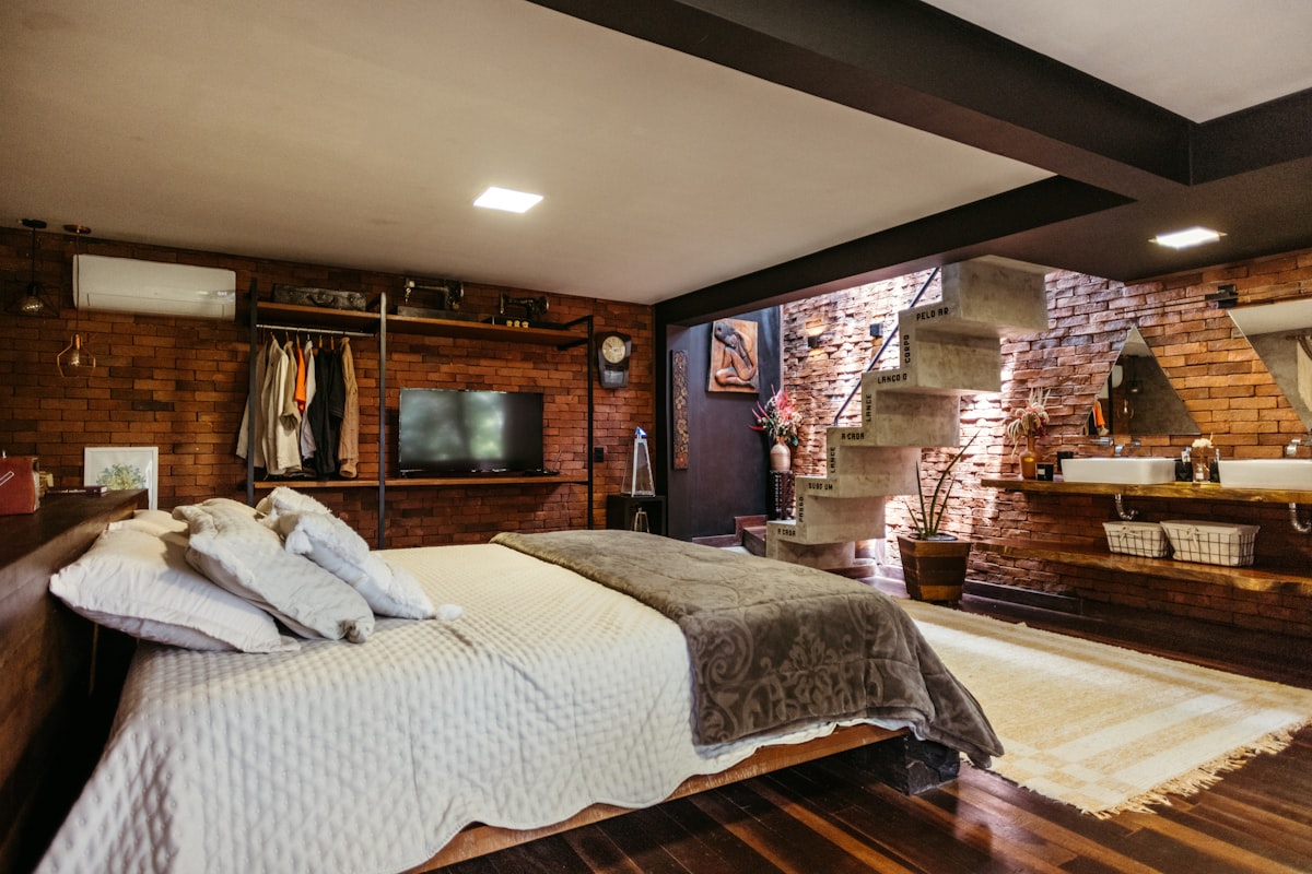 A bedroom with a bed, dresser and mirror related to Maximizing Space: The Ultimate Guide to Loft Beds with Stairs and Desk Solutions