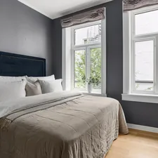 A bedroom with a bed, dresser, and two windows related to Grey Bed Valance: Add Sophisticated Style to Your Bedroom