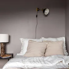 A bedroom with a bed, nightstand and lamp related to Elevate Your Bedroom with Gray Linen Bedding