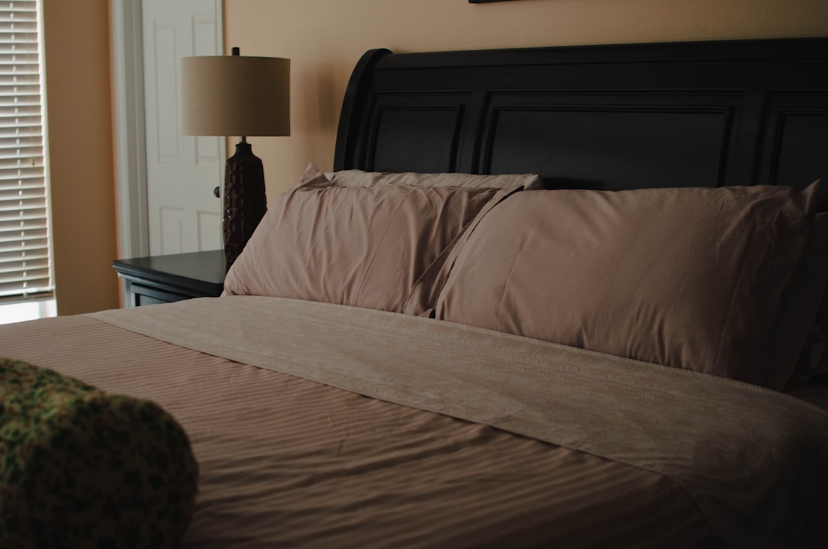 a bedroom with a bed, nightstand, and window related to King Size Coverlet Sets