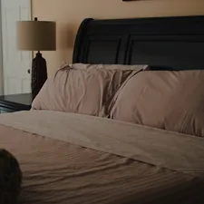 a bedroom with a bed, nightstand, and window related to King Size Coverlet Sets