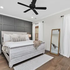 a bedroom with a large bed and a ceiling fan related to Elevate Your Bedroom with a Queen Quilted Coverlet