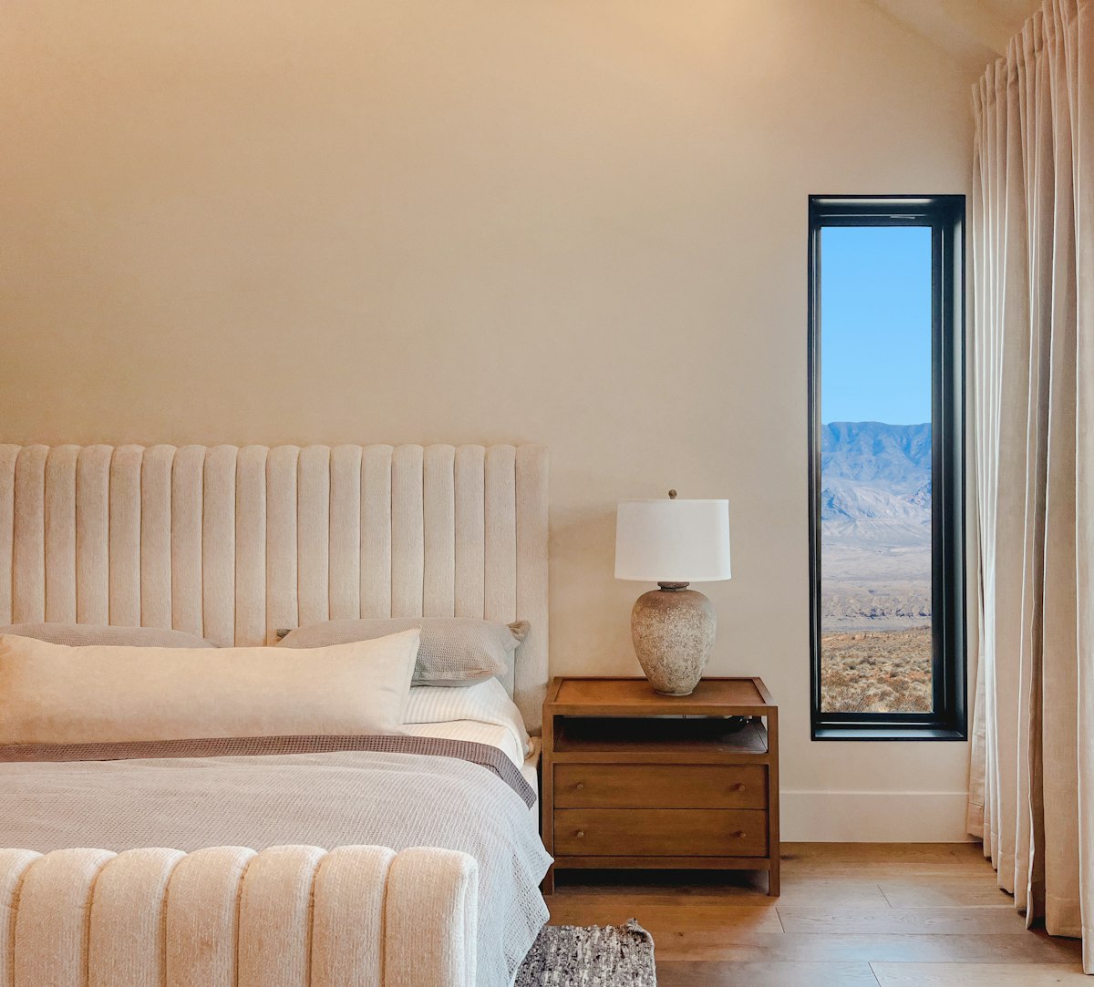 a bedroom with a large bed and a large window related to The Ultimate Sleeping Experience: California King Bed