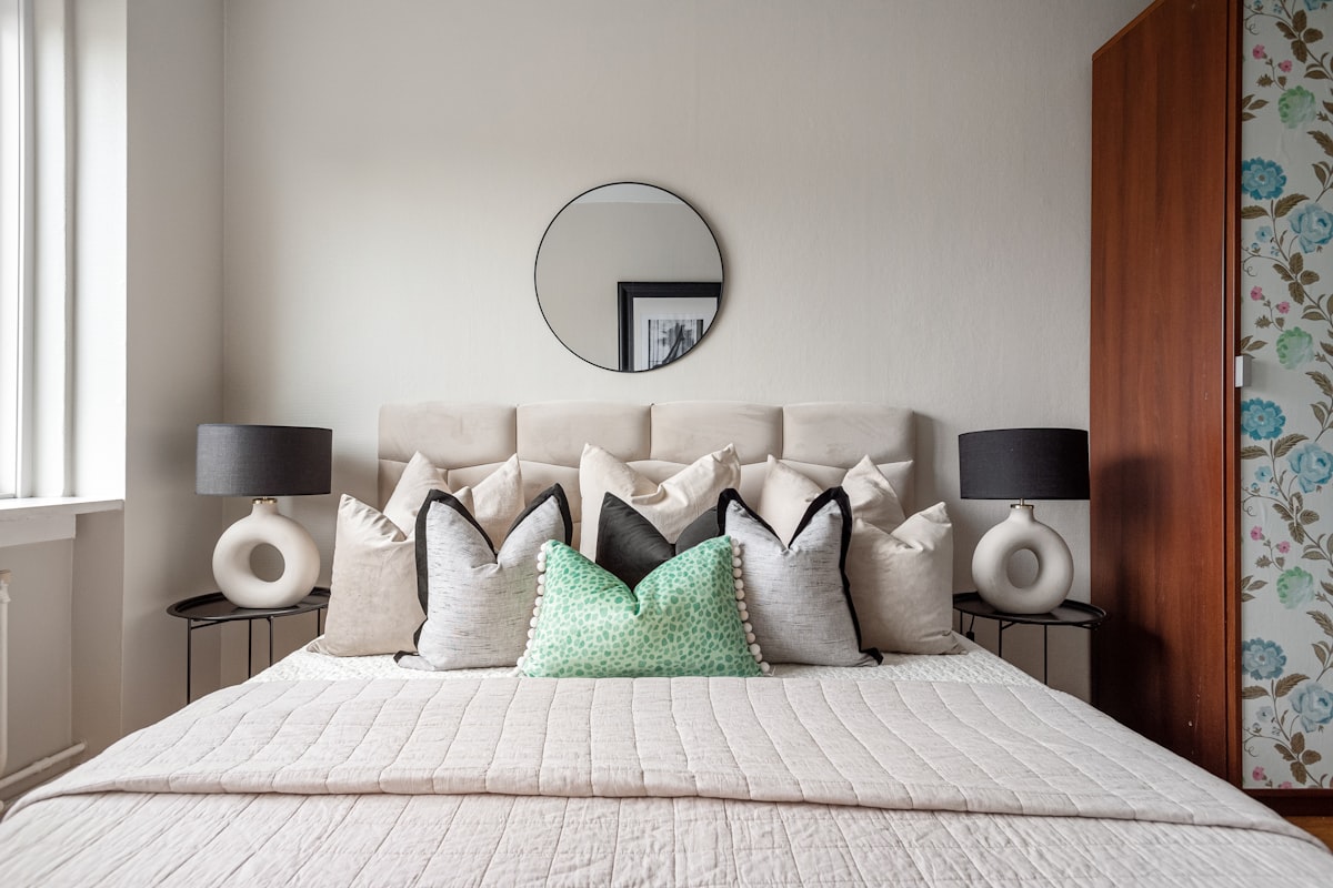 A bedroom with a large bed and a mirror on the wall related to Transform Your Bedroom with Mint Green Chevron Bedding