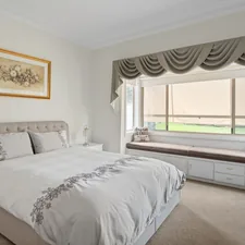 A bedroom with a large bed and a window related to The Ultimate Guide to Tier and Valance Sets: Elevating Your Windows and Rooms