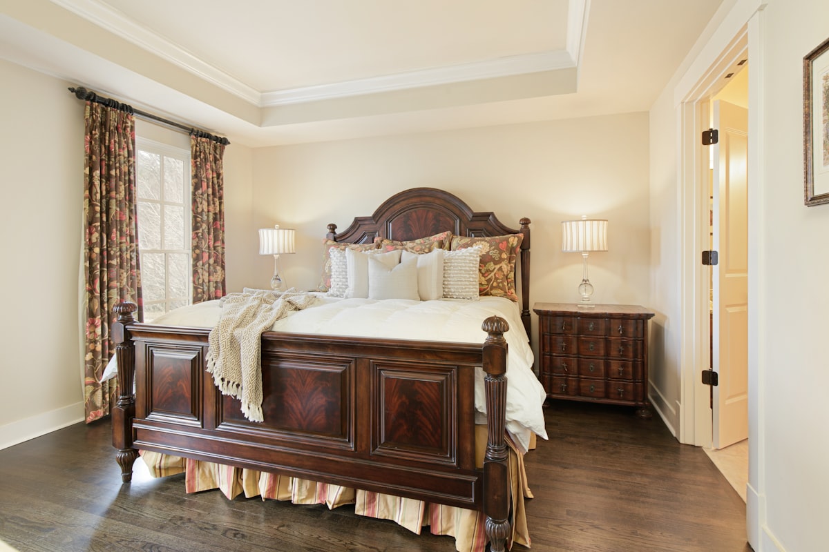 A bedroom with a large bed and a wooden dresser related to King Size Matelasse Coverlet: Elegant Bedding for a Regal Sleep