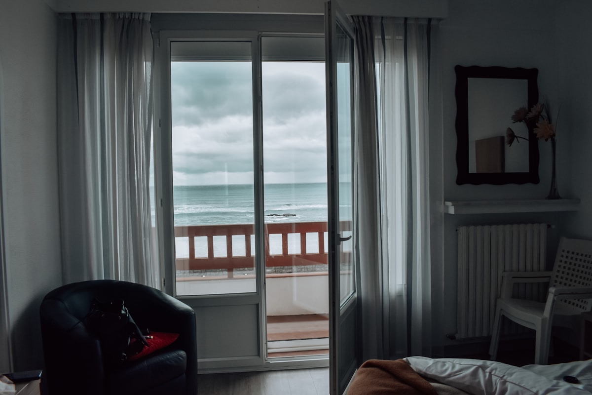 a bedroom with a sliding glass door leading to a balcony related to Escape to Paradise: Amelia Oceanfront Bed & Breakfast in Fernandina Beach, FL