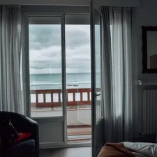 a bedroom with a sliding glass door leading to a balcony related to Escape to Paradise: Amelia Oceanfront Bed & Breakfast in Fernandina Beach, FL