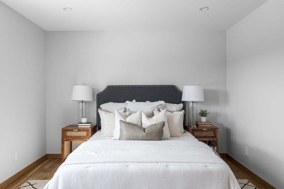 A bedroom with a white bed and two nightstands related to Elegant White Coverlets for Twin Beds