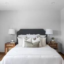 A bedroom with a white bed and two nightstands related to Elegant White Coverlets for Twin Beds