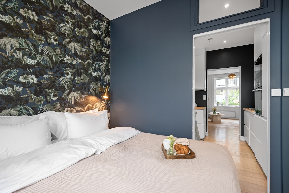 A bedroom with blue walls and a white bed related to Experience the Charm of Bed and Breakfast in Julian: A Cozy Getaway