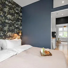 A bedroom with blue walls and a white bed related to Experience the Charm of Bed and Breakfast in Julian: A Cozy Getaway