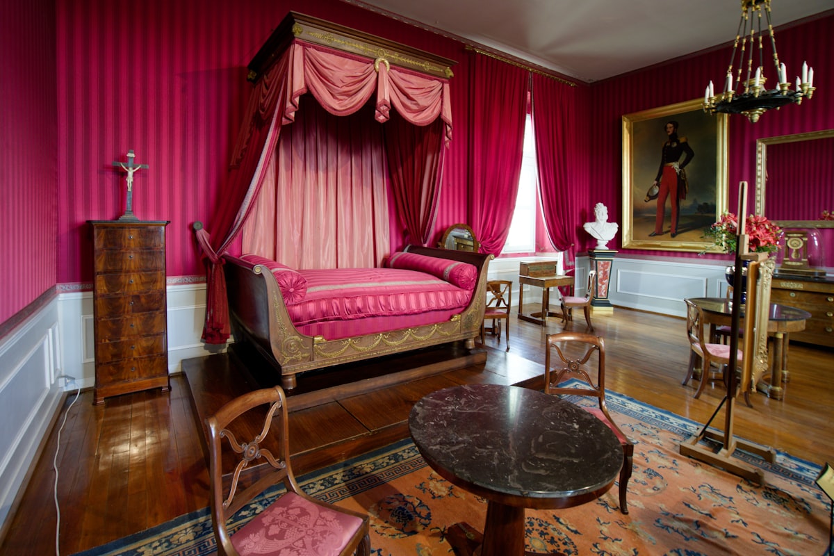 a bedroom with pink walls and a canopy bed related to Dreamy Escapes: The Allure of Pink Canopy Beds