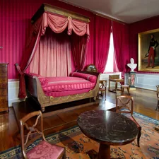 a bedroom with pink walls and a canopy bed related to Dreamy Escapes: The Allure of Pink Canopy Beds